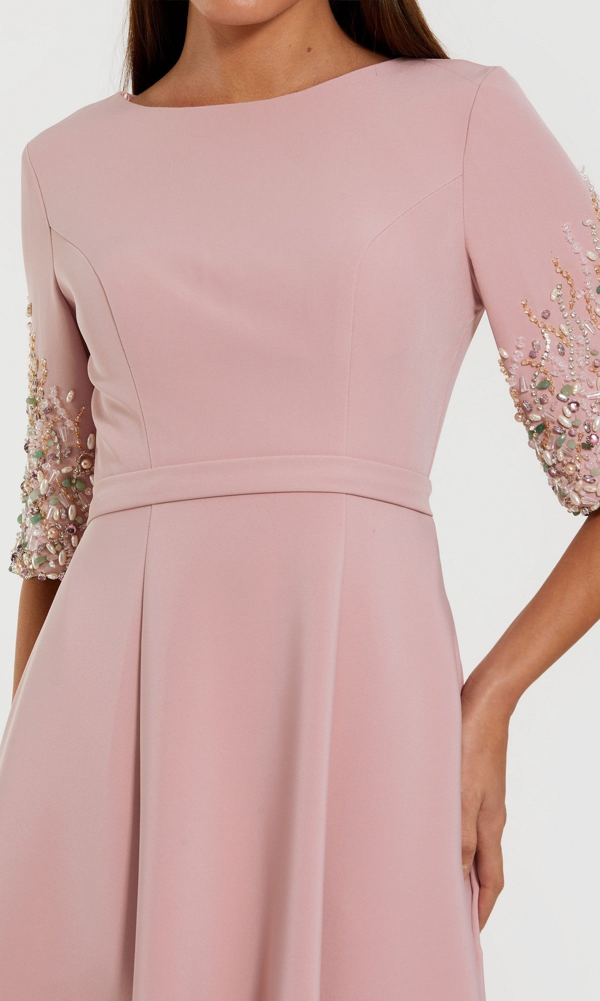 A woman confidently poses in the Mac Duggal 2322 long formal dress—a light pink crepe evening gown featuring embellished sleeves and an A-line skirt.